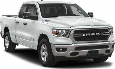 Front-side view of pickup with bold grille and quad cab doors.