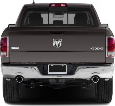 Pickup rear view with chrome bumper, dual exhaust, and 4x4 badge