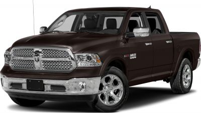 Front grille and chrome alloy wheels of a crew cab short pickup.
