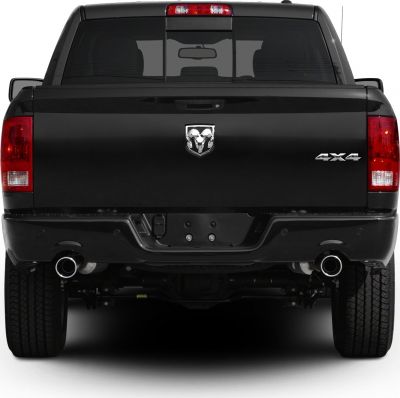 Rear view of black pickup with dual exhaust and 4x4 badge