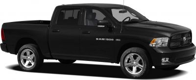 Black pickup truck with chrome wheels, RAM 1500 badge, side profile