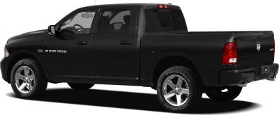 Black pickup with extended cab, 4x4 badge, chrome wheels, and dual exhaust