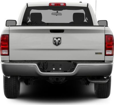 Rear view showing pickup tailgate, bumper, and exhaust pipe