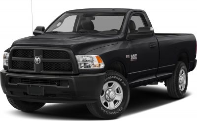 Front-side view of black pickup with prominent grille and headlight.