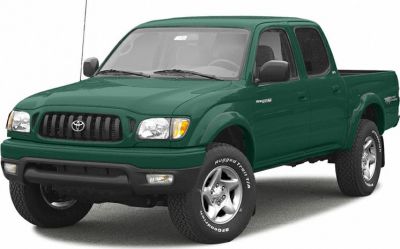 Dark green crew cab pickup with rugged off-road tires and front grille design