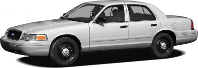 Silver full-size sedan with black steel wheels and police spotlight