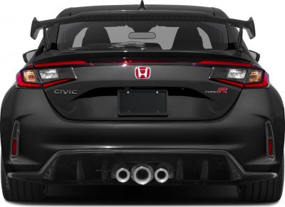Triple center exhaust and large rear spoiler on a sporty hatchback rear
