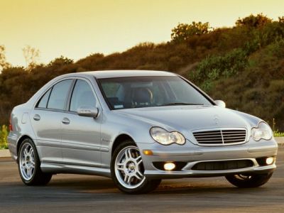 Silver four-door sedan with rounded headlights and chrome grille