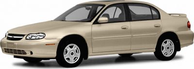 Beige sedan with rear spoiler and alloy wheels