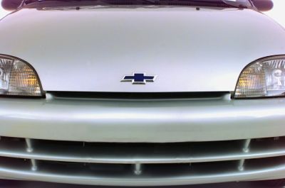 Close-up of car front grille, headlights, and emblem