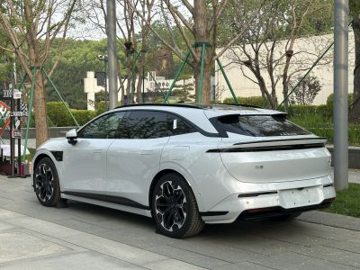 Rear and side view of sleek modern sedan with futuristic taillights and alloy wheels