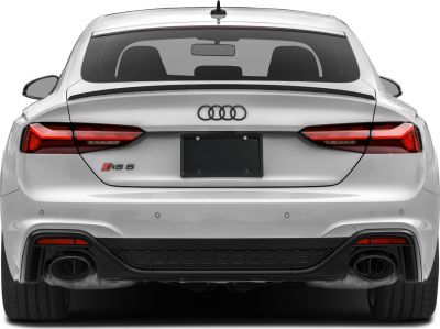 Rear view with taillights, quad exhausts, diffuser, and badge