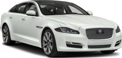 White luxury sedan front three-quarter view with grille and headlights
