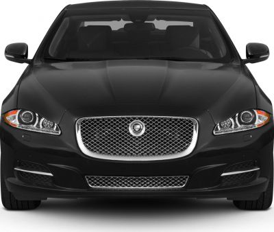 Luxurious front grille and dual headlights of a sleek black sedan