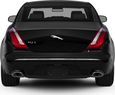 Rear view with distinct taillights and dual exhausts on a luxury sedan.