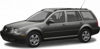 Side profile of a four-door station wagon with alloy wheels and roof rails.