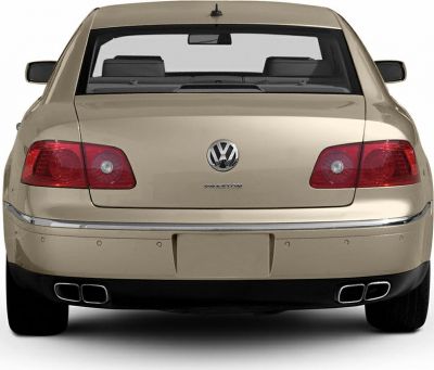 Rear view with dual exhaust pipes and distinct tail lights.
