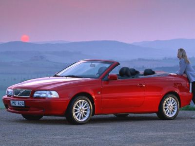 Red convertible with soft-top roof and alloy wheels