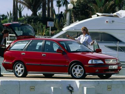 Red four-door wagon with side view and open rear hatch