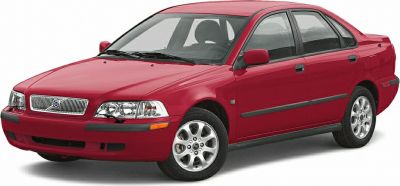 Red compact sedan with distinct front grille and alloy wheels