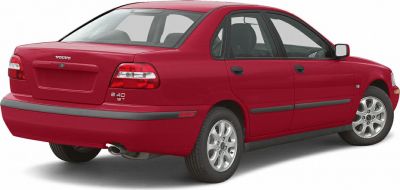 Rear and side view of a red compact sedan with tail lights and alloy wheels