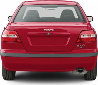 Rear end of a car highlighting tail lights, rear window, and exhaust pipe