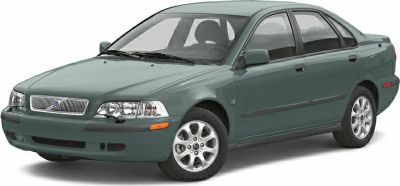 Front corner view of a green compact sedan with signature grille and multi-spoke wheels.