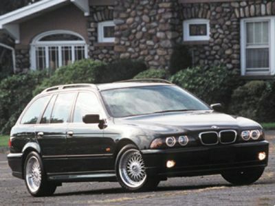 Front-side view of a classic station wagon with distinctive headlights and alloy wheels