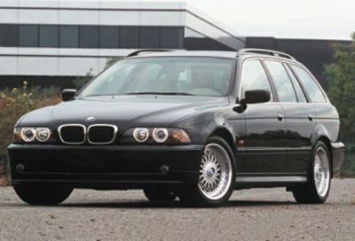 Front side view with dual round headlights and alloy wheels
