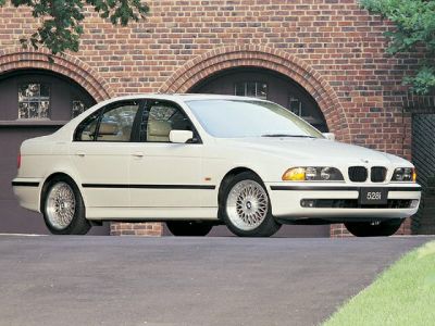 Classic sedan with rounded headlights and multi-spoke alloy wheels