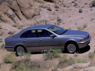 Classic sedan side profile with distinctive wheel design and smooth lines