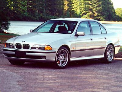 Front three-quarter view of a silver mid-1990s sedan with alloy wheels
