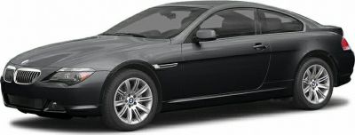Side profile of a dark-colored two-door coupe with alloy wheels