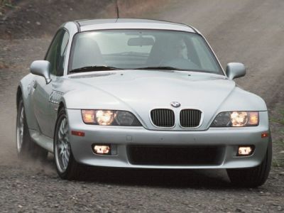 Front view with headlights and fog lights on, distinctive kidney grilles visible