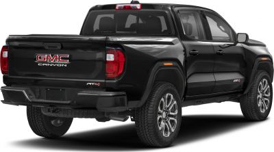 Rear and side view of a black pickup truck with AT4 badge