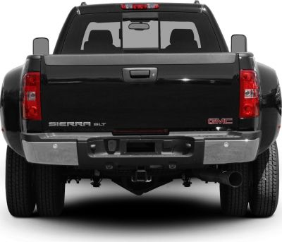 Rear view of dual rear wheel extended cab long box pickup.