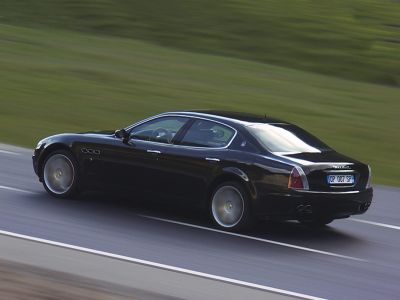 Rear side profile of a luxury sedan in motion