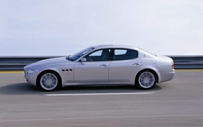 Sleek luxury sedan with side air vents and long streamlined profile.