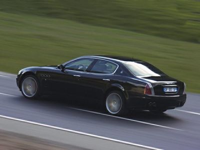 Rear three-quarter view of a luxury sedan in black