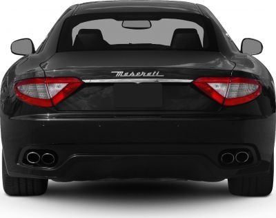 Rear view with distinct tail lights and dual quad exhaust pipes
