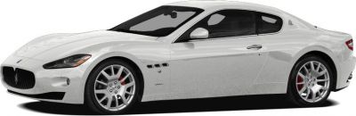 White sports coupe with alloy wheels in side profile