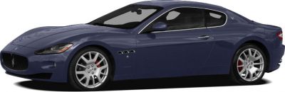 Side profile of a two-door coupe with alloy wheels and smooth aerodynamics