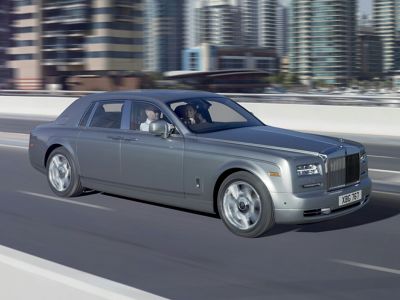 Silver luxury sedan cruising on urban road