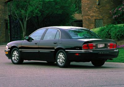 Rear side view of luxury sedan with chrome wheels