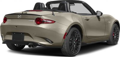 Convertible rear three-quarter view with black multi-spoke wheels and dual exhaust.
