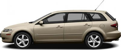 Side profile of a beige mid-size station wagon with alloy wheels and four doors.