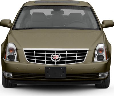 Front view of luxury sedan with chrome grille and vertical dual headlights