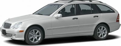 Side profile of a silver estate with alloy wheels and roof rails