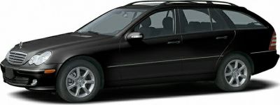 Side view of a black station wagon with alloy wheels and roof rails.
