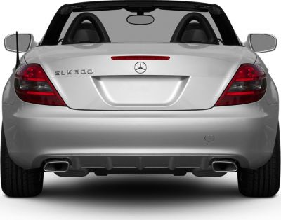 Rear view of a convertible with taillights and dual exhaust pipes